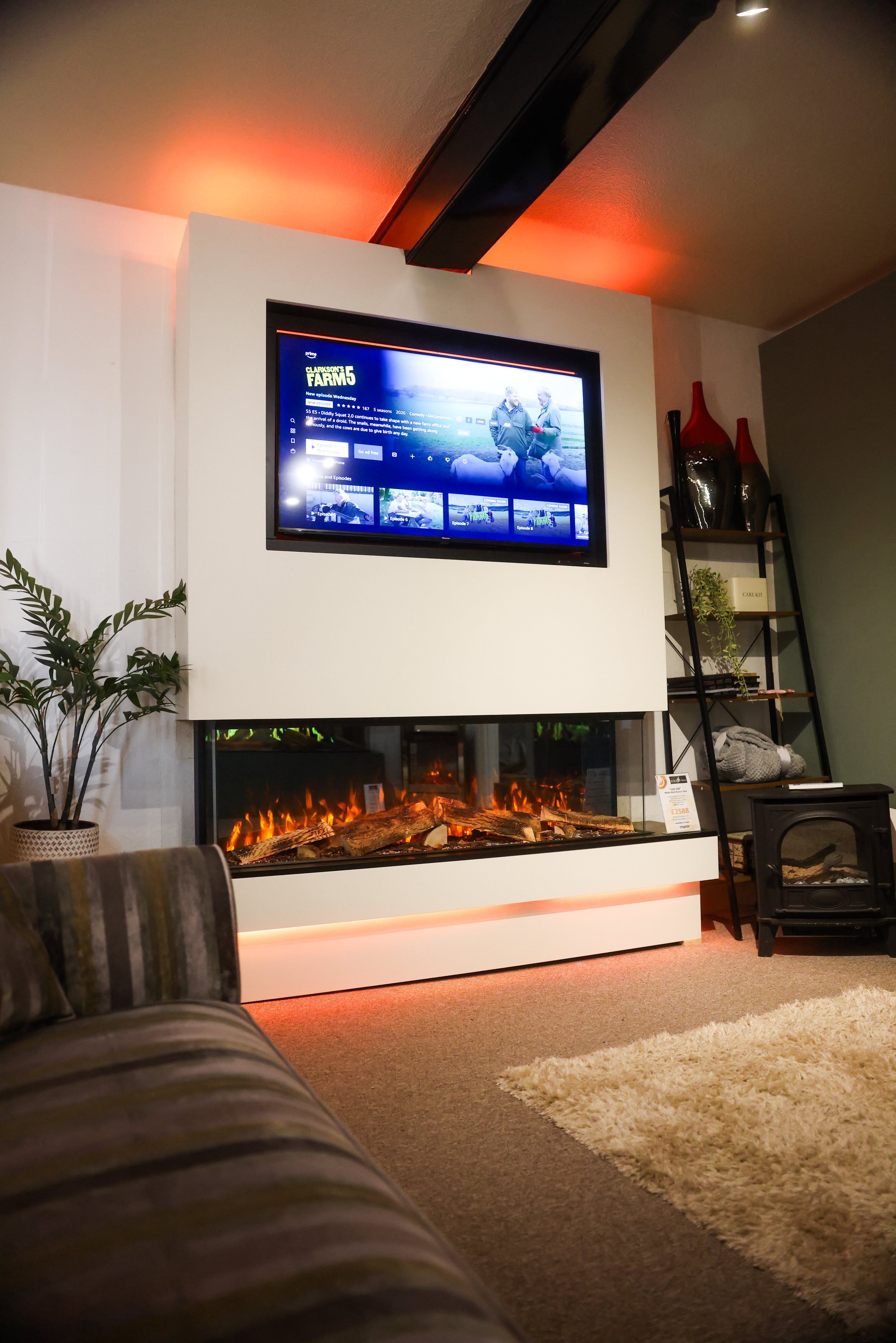 Contemporary media wall with integrated shelving and electric fire